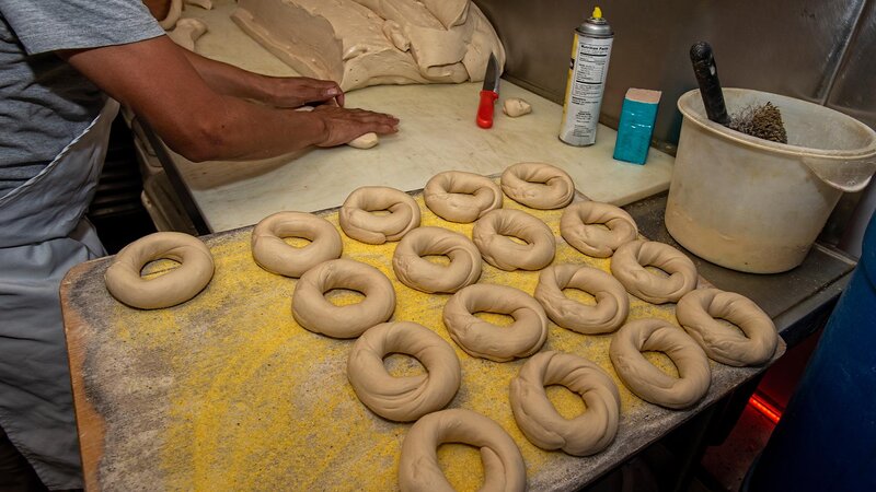 Dough being shaped into bagels