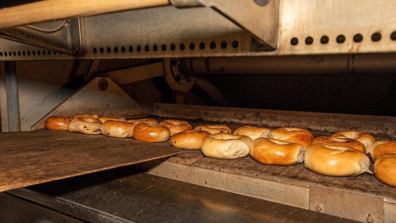 Many bagels inside of an oven