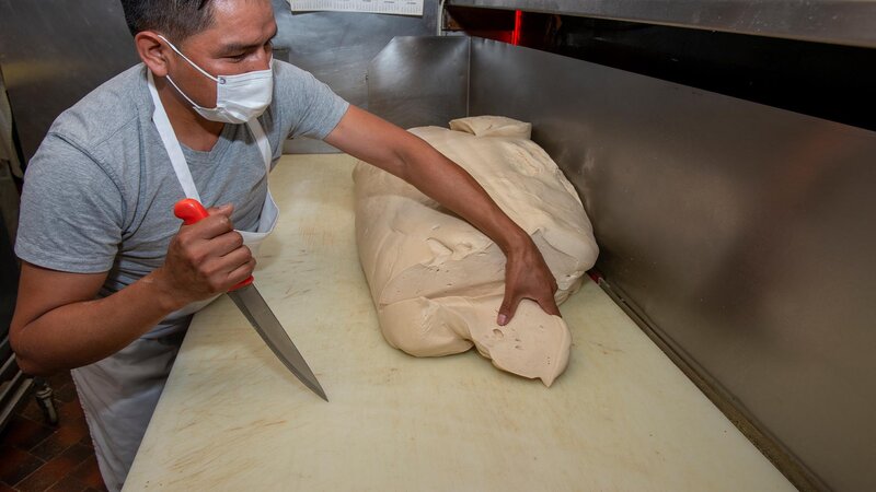 Staff cutting up uncooked dough