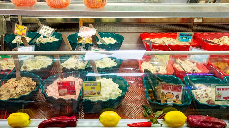 Different types of cold salads in a display case